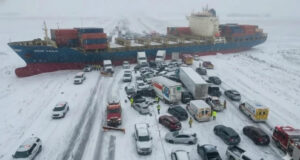 Image of pileup with containership across the highway.